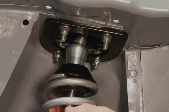 27. Install the spring on the coil over shock and install the lower crossbar following the