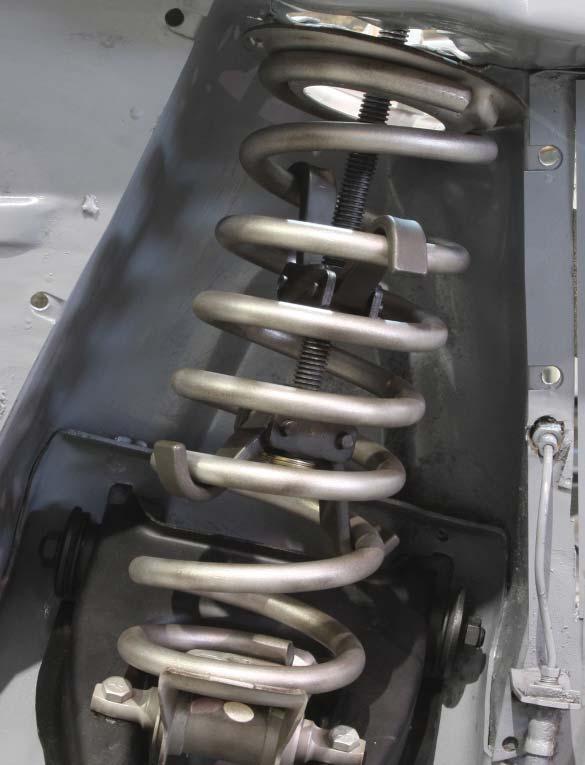 10. Using a spring compressor, remove the coil spring.
