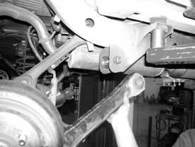 SEE REAR SUSPENSION INSTRUCTIONS: 36. Jack up the rear end of the vehicle and support the frame rails with jack stands just in front of the rear bumper.
