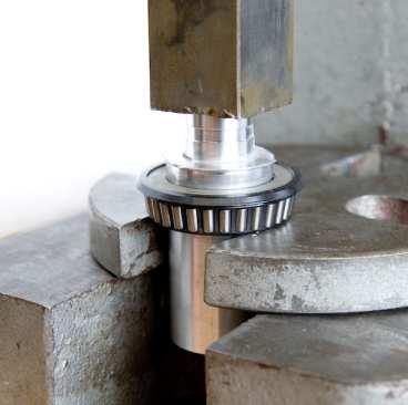 Press taper bearing and seal off of steerer tube with an arbor or hydraulic press.