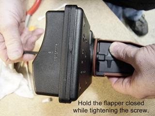 After lightly snugging the screw you will want to hold the flapper toward the closed position while fully tightening.
