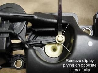 #9 Next you need to remove the retaining clip that holds the vacuum lever onto the bell crank lever. Work the clip off by prying up under clip with a small flat blade screwdriver.
