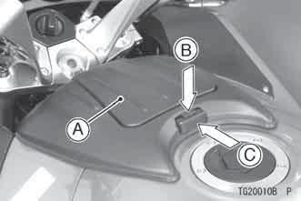 To open the storage compartment lid- Unlock the lid of the storage compartment by pushing the lever in with holding the button down. The lid will open automatically. A. Storage Compartment Lid B.