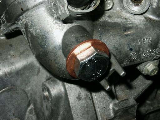 11. Install the supplied bolt and washer to plug the coolant passage on the driver side