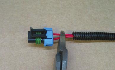 3 At the harness end of the weather-pac, pull back the wire loom. There will be two red wires.