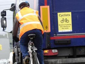 is a warning sign on the back of lorries alerting cyclists to the dangers of undertaking these vehicles.
