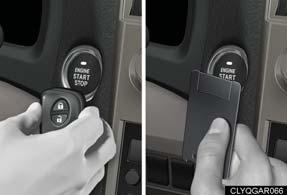 Touch the Lexus emblem side of the electronic key to the ENGINE START STOP switch.