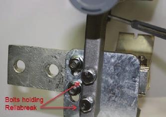3. Remove the Reliabreak unit. 4. Line up the through-holes on the Reliabreak mounting arm with the threaded holes in the L-bracket. 5.