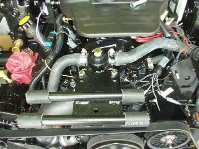 Connect the existing hoses (if usable) from the bottom of the exhaust manifold to either side of the Lower Bracket Assembly.