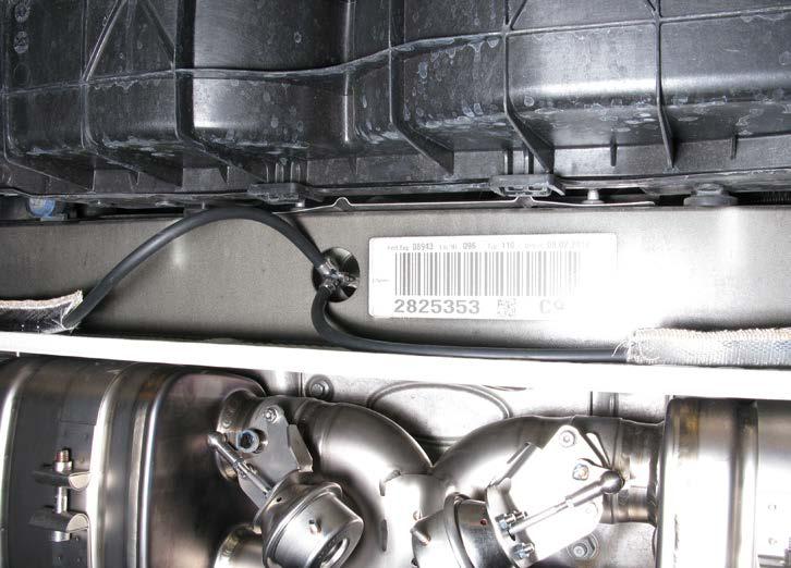 12. For vehicles with sports original exhaust system only: redirect the stock vacuum outlet tube as shown and bind