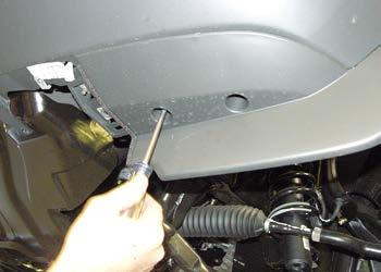 Start by removing three plastic fasteners located behind the grille,