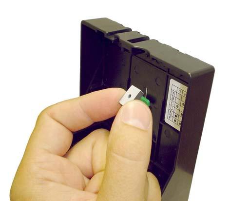 Insert a magnet into the slot with its white sides oriented as shown in the figure below, i.e. both white surfaces facing the exterior of the cartridge. NOTE: This is VERY IMPORTANT!