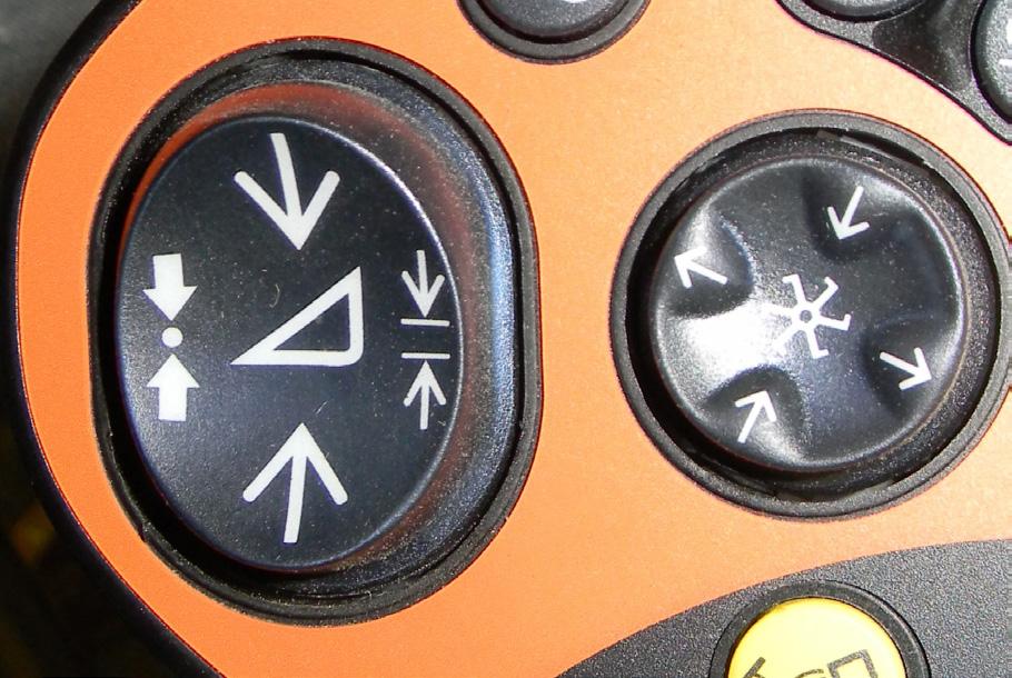 The Left Side button (arrows to dot) is Active Header Height (AHHC). For all heads with height sensors on the head The Right Side button (arrows to lines) is Feeder Position (Return to Cut or RTC).