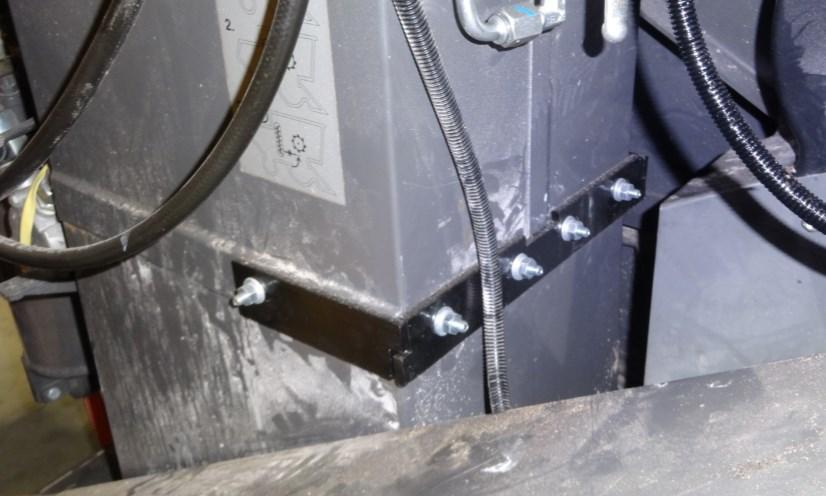The chain will need to be partially fed up the elevator in order to gain access to insert the bolts.