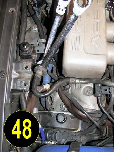 Loosen the fuel line at each end and remove the hose.