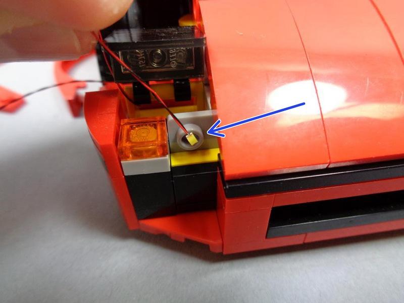 As shown by the blue square, tilt up the headlight cover so you can feed the LED wire through the