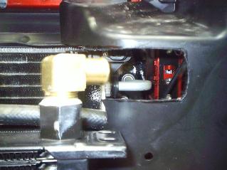 Center radiator and position it as far back as possible on the frame rail. Otherwise it will interfere with the grill.