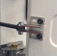 Start by loosely bolting the door catch back with the new bracket and supplied washers as shown.