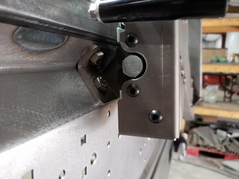 Close the swing arm and align the slam latch pin to be directly in the center of the slam latch.