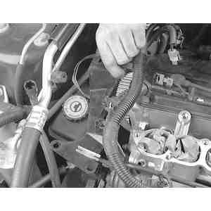 10: Loosen the power steering fluid reservoir mounting bracket bolts... Fig. 11:.