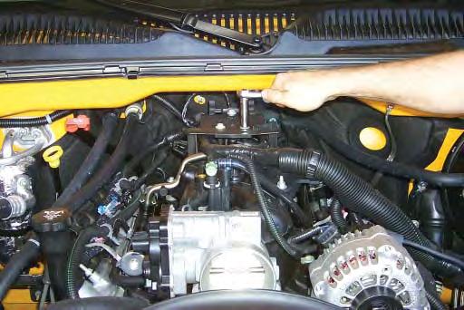 44. Using a 10mm socket wrench, remove the three bolts that fasten the