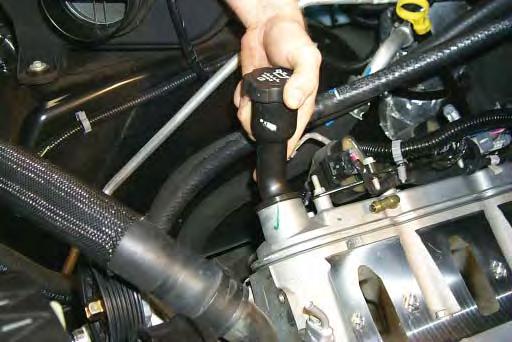 68. Remove the long oil fi ller neck from the valve cover by rotating it