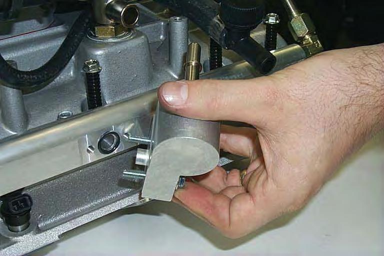 Install the assembled fuel manifold to the driver side fuel rail using the two new supplied 6mm bolts.