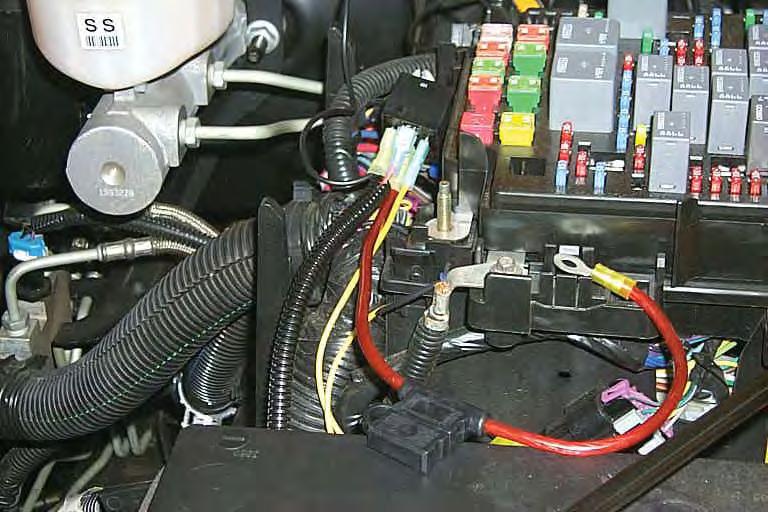 132. In the wiring below the fuse/relay center, locate the gray fuel pump wire that goes from the relay center down the frame towards the rear of