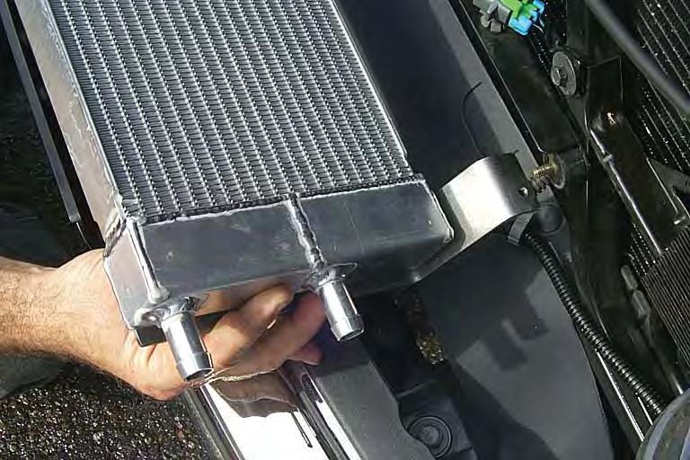Install the heat exchanger onto the studs of the rubber mounts and