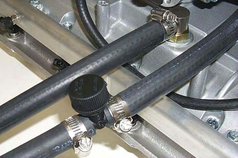 From the remaining length of hose, connect one end to the inlet barb of the intercooler reservoir with a #10 clamp. 166.