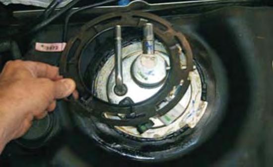 USE A NON METALLIC HAM- MER OR DRIFT to remove the lock ring by tapping the ring