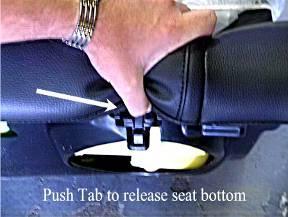 1. Remove Back Seat: A) Locate the retainers securing the seat bottom into the vehicle, approximately 10 inches from