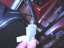 From the back of the connector (no need to disconnect/separate connector halves), push the metal terminal of the Light Bar Wiring Harness Black wire into the same connector opening along side the