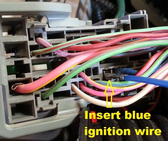6. Remove the connectors wire cover, then Insert the terminal on the blue wire into the empty cavity next to the large diameter blue wire as shown.
