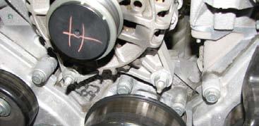 engine bay 30. Loosen the tensioner arm by using a 1/2 drive breaker bar, and remove the serpentine belt.