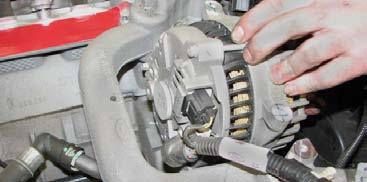 Use a 10mm socket to remove the two upper front bumper cover bolts, located between the grille and headlights.