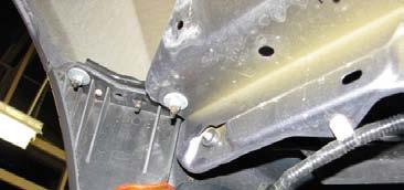 38. Reach through the fender well with a 10mm socket to loosen the two nuts on each side that attach the