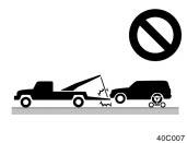 (c) Towing with sling type truck (c) Towing with sling type truck NOTICE Do not tow with sling type truck, either from the front or rear.