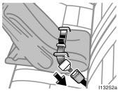 1. Run the center lap belt through or around the infant seat following the instructions provided by its manufacturer and insert the tab into the buckle taking care not to twist the lap belt.