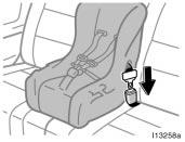 Run the center lap belt through or around the convertible seat following the instructions provided by its manufacturer and insert the tab into the buckle taking care not to twist the lap belt.