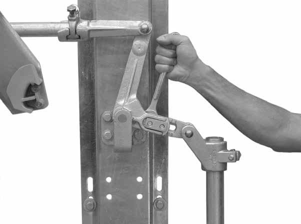 Move the operating handle to its mid-position to take the strain off the operating-pipe linkage and loosen the two bolts that clamp the driving arm of the adjustable bell crank. See Figure 33.