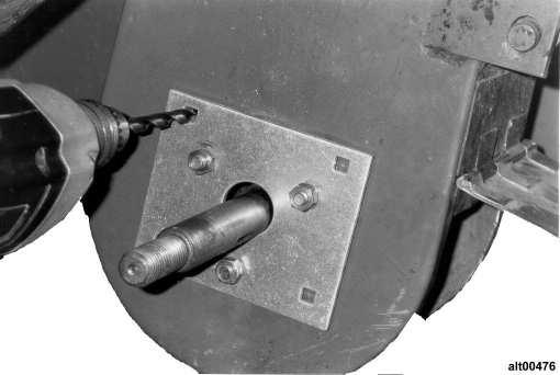 2. Fasten drill template to lower boot (as shown in Figure 16) using existing fasteners that secured original bearing. Figure 16. Mounting plate to remove 3.