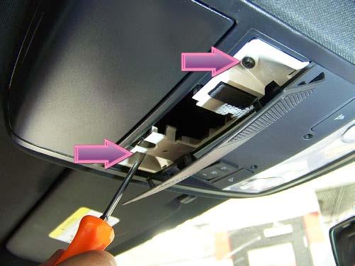 (arrows) securing the dome light assembly. Lower the assembly from the headliner.