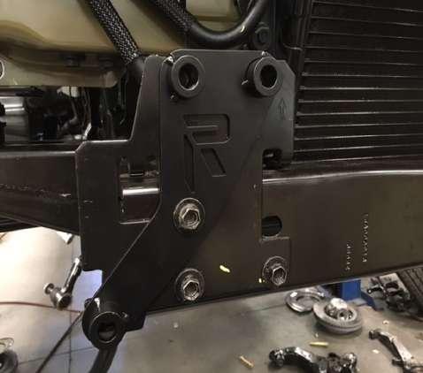 The driver side bracket is marked with an L and the passenger side bracket is marked with a R. Secure the brackets in place using the previously removed OE 10mm bolts. 22.