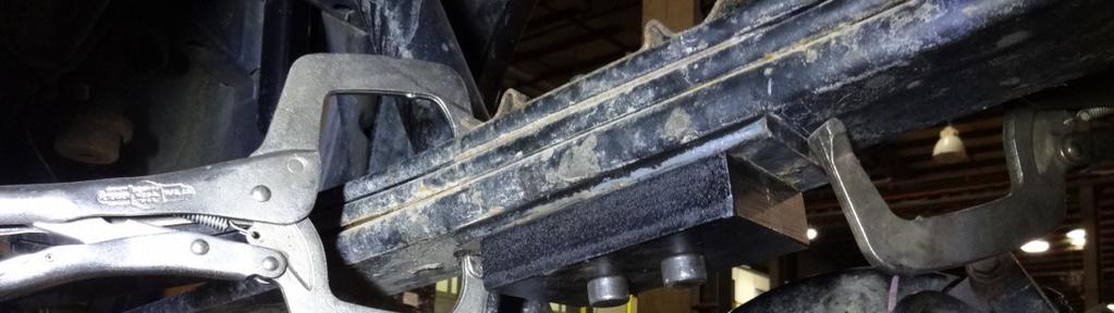 INSTALL TWO OF THE SUPPLIED ½ CENTER PINS UP THROUGH THE NEW SUPPLIED LEAF SPRING PACKER. B.