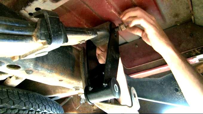 13. Place emergency brake cable in