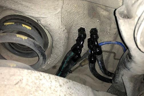 Install the double-ended hose barb fitting into the BMW rubber hose and secure with one of the included EFI hose clamps. Slightly bend the fuel return pipe so that it angles as shown.