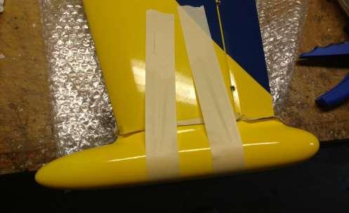 Masking tape clamps while the glue sets 9) Installing the wings onto the fuselage: The wings slide over 2