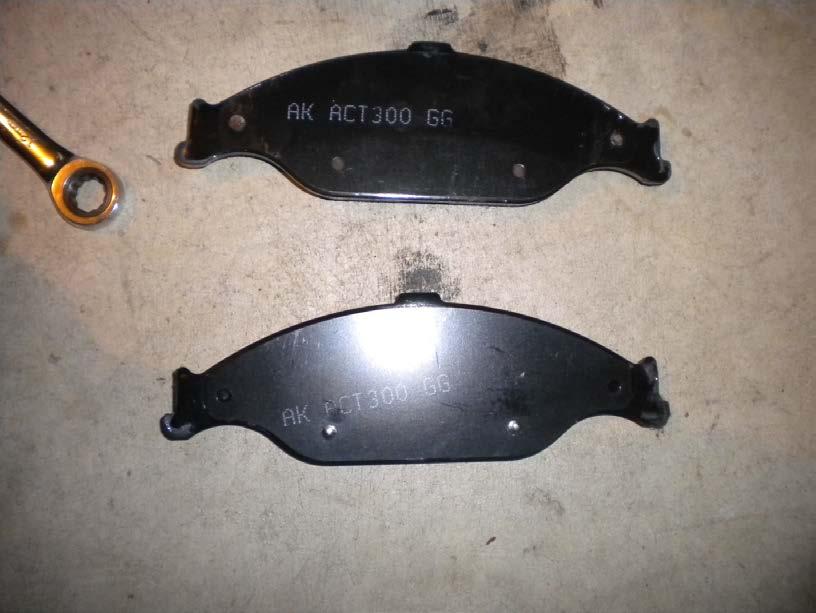 Properly lubricated brake pad that will come in contact with the calipers pistons (the brake pad closet to the engine). The other brake pad just requires lubrication on the ends. 9.