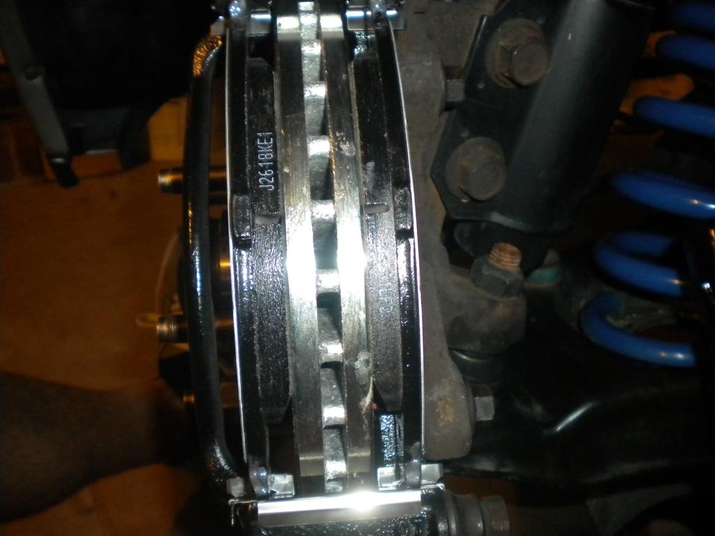 10. Replace the studs into the caliper bracket, and position the caliper over the brake pads.